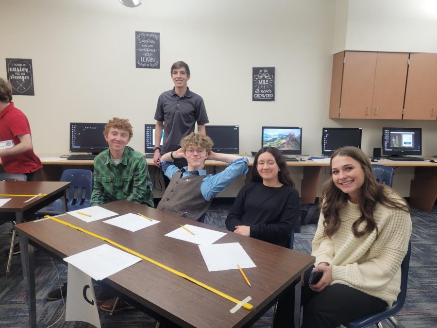 From left, seniors Kalin Hicswa, Daniel Merritt, Ethan Cearlock, junior Kik Hayano, and senior Syndey Spomer sit around their designated table as they prepare for the competition.

