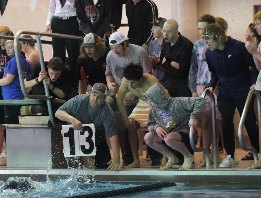 Members of the Panther boys swim team gather around senior Kobus Diver’s lane as he swims his 500 yard freestyle. Diver placed eighth in this event. 