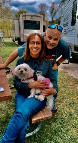 Mr. and Mrs. McKenzie pause for a quick photo with their dog during a summer camping trip.