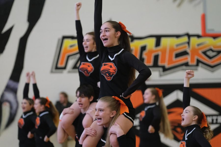 The Panther Cheer team performs their state routine at a home basketball game after State Cheer was cancelled.  The team ended up taking fourth at state.