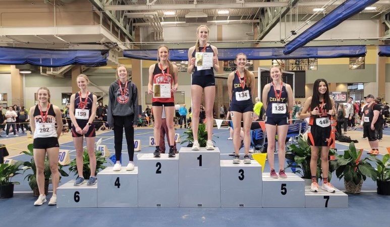 Senior+Anna+Bartholomew+stands+at+eighth+on+the+podium%2C+cementing+her+place+as+the+first+girl+in+Powell+High+School+Indoor+Track+history+to+do+so+in+her+event%2C+the+800+Meter+Dash.++%0A