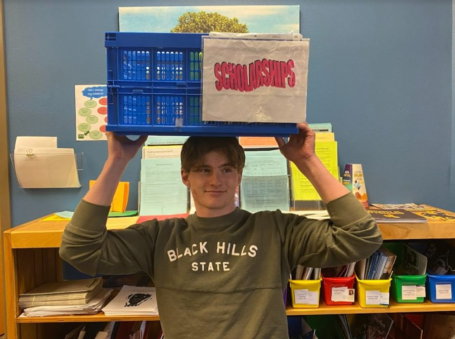 Senior Austin Graft surrounds himself with scholarships and college admission information in hopes of discovering a scholarship with standards as low as his self esteem.