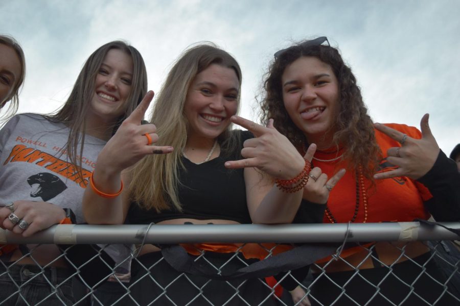 High school girls decked out in orange and black for a football game. Pictured left to right, junior Waycee Harvey, and seniors Maddie Campbell and Aniah Diaz. 