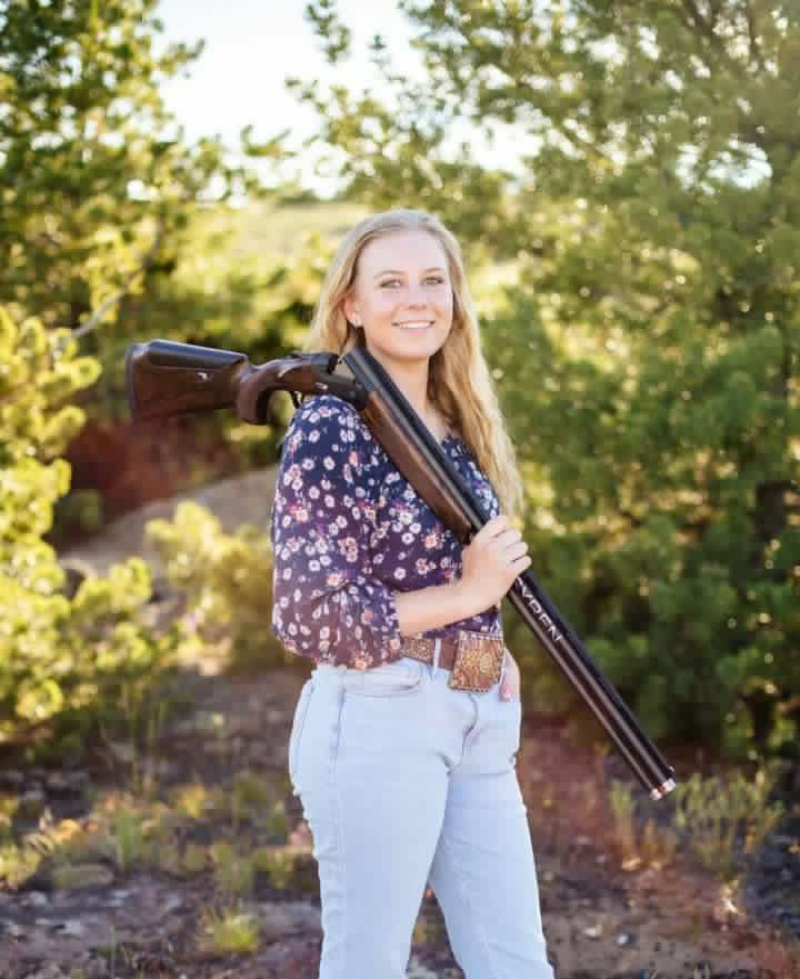 Senior Hannah Sears slings her competition shotgun over her shoulder for a senior photo. Sears will continue her shooting career at Hastings College.
