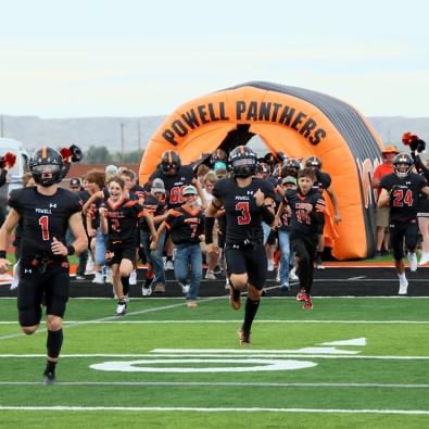 The Panther football team storms out of the tunnel, prepared to take down the Worland Warriors for the first time on the newly laid turf. 