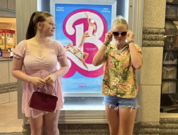 Allie and Ava Gilliatt posing in front of the Barbie movie poster.