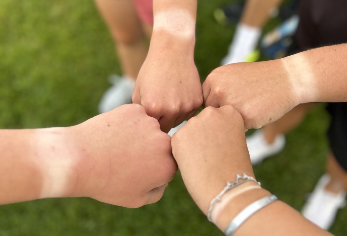 Members+of+the+Powell+High+School+tennis+team+show+off+their+wrist+tanlines.+