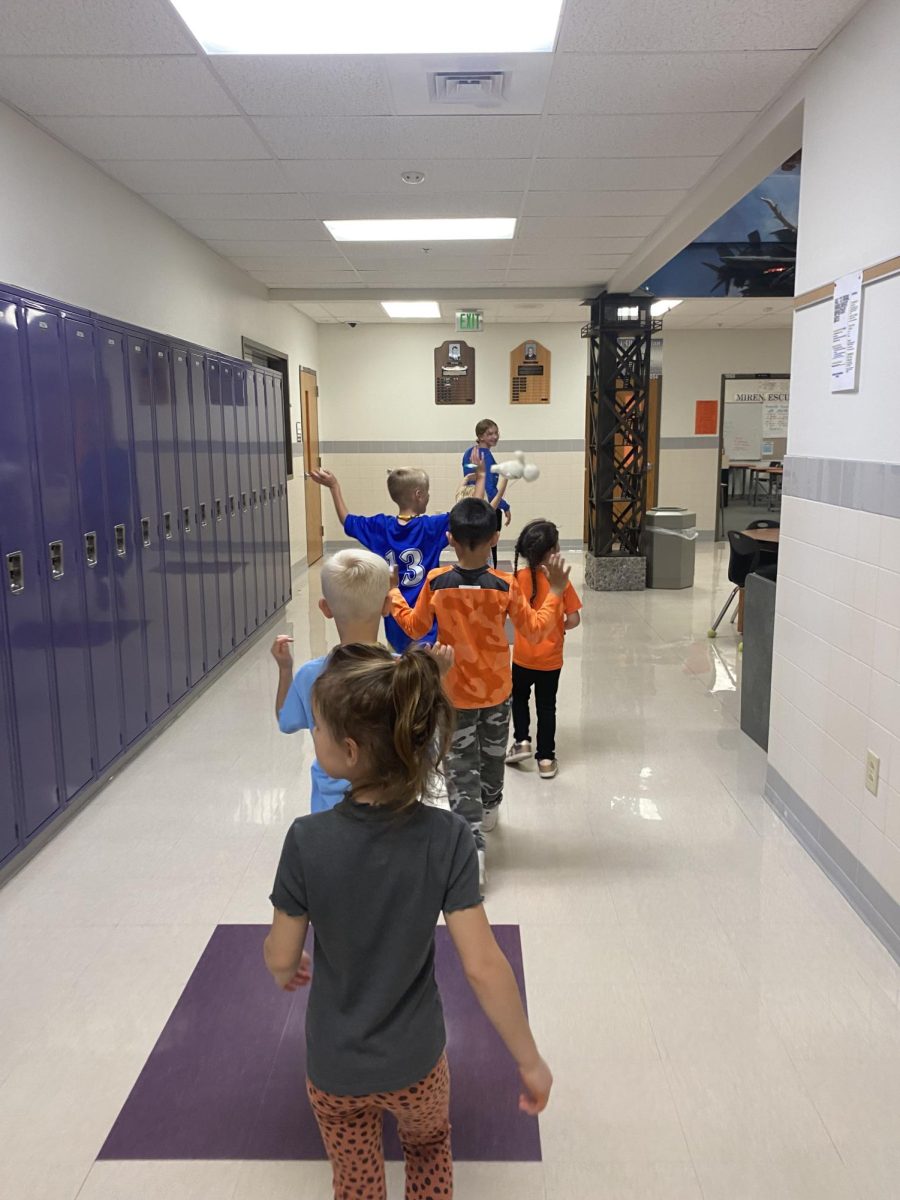 Playing line leader, the group of children march around Powell High School in an orderly manner. Photo Courtesy of Kendal Eden.