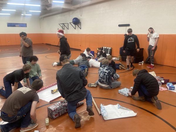 PHS wrestling team tries their hardest to get presents wrapped.