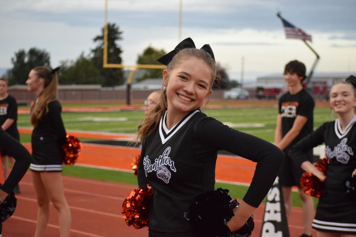 Maddie Johnson smiles directly to the camera, looking to give some of her Panther Pride through the lense.