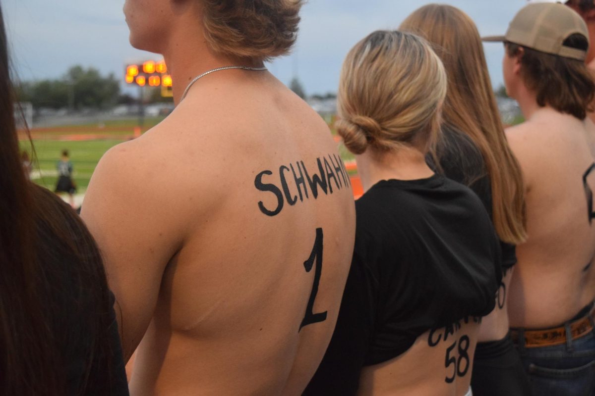 Completed by the student section for the past couple of years, some students will show their support for seniors and certain athletes by painting up and writing their last name and number on their back. 