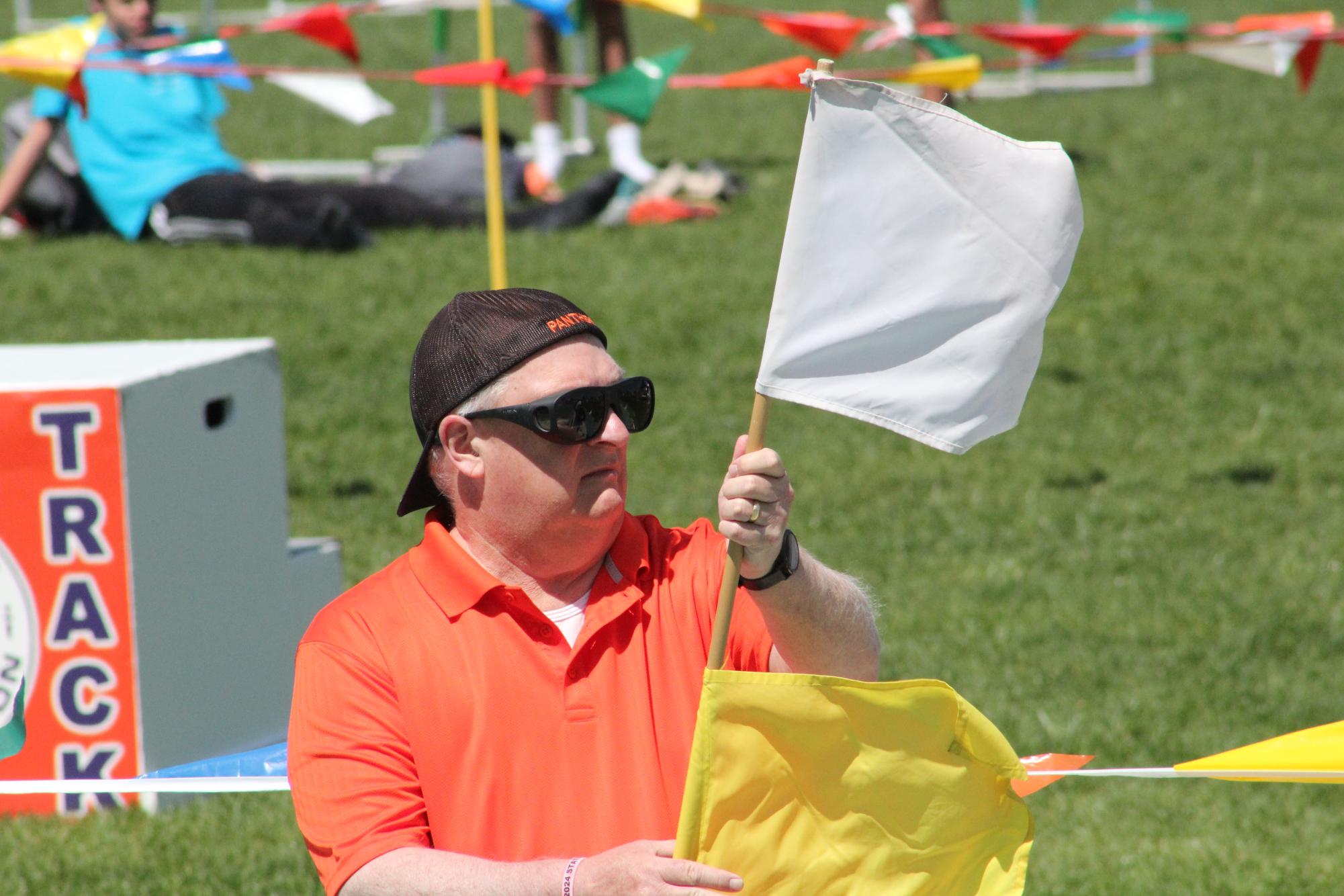 Coach Scott Smith waves the white flag, motioning that everything is all clear