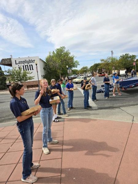 Members of the Powell-Shoshone FFA chapter stand in line while holding pies to be auctioned off.