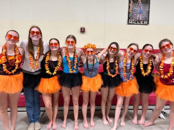 Powell swimmers pose for a picture in their tutus after a swim meet.