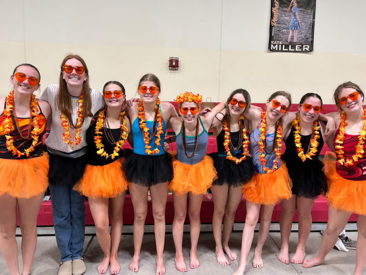 Powell swimmers pose for a picture in their tutus after a swim meet.