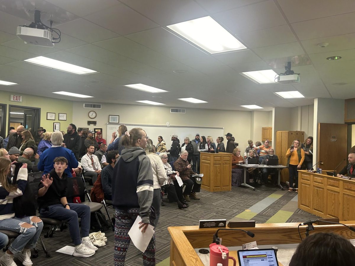 Community members attempt to accommodate the large audience at the PCSD1 school board meeting.