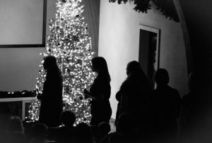 Performers hold candles as they walk to the stage at the Vespers concert on December 4th. 