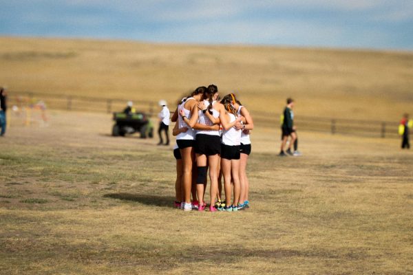 Lady Panthers take a moment to pray before the race.