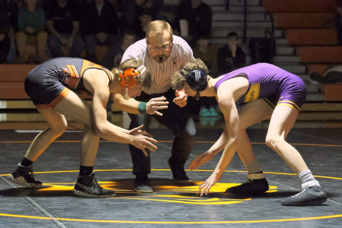 Senior Wyatt Nicholson, on the left, intensely stares down his opponent as the match begins.