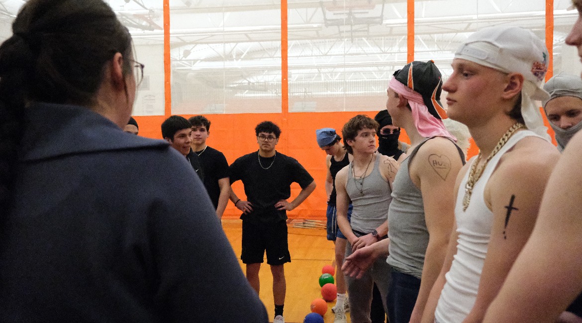 The participants of the dodgeball fundraiser getting told the rules before the hectic games.