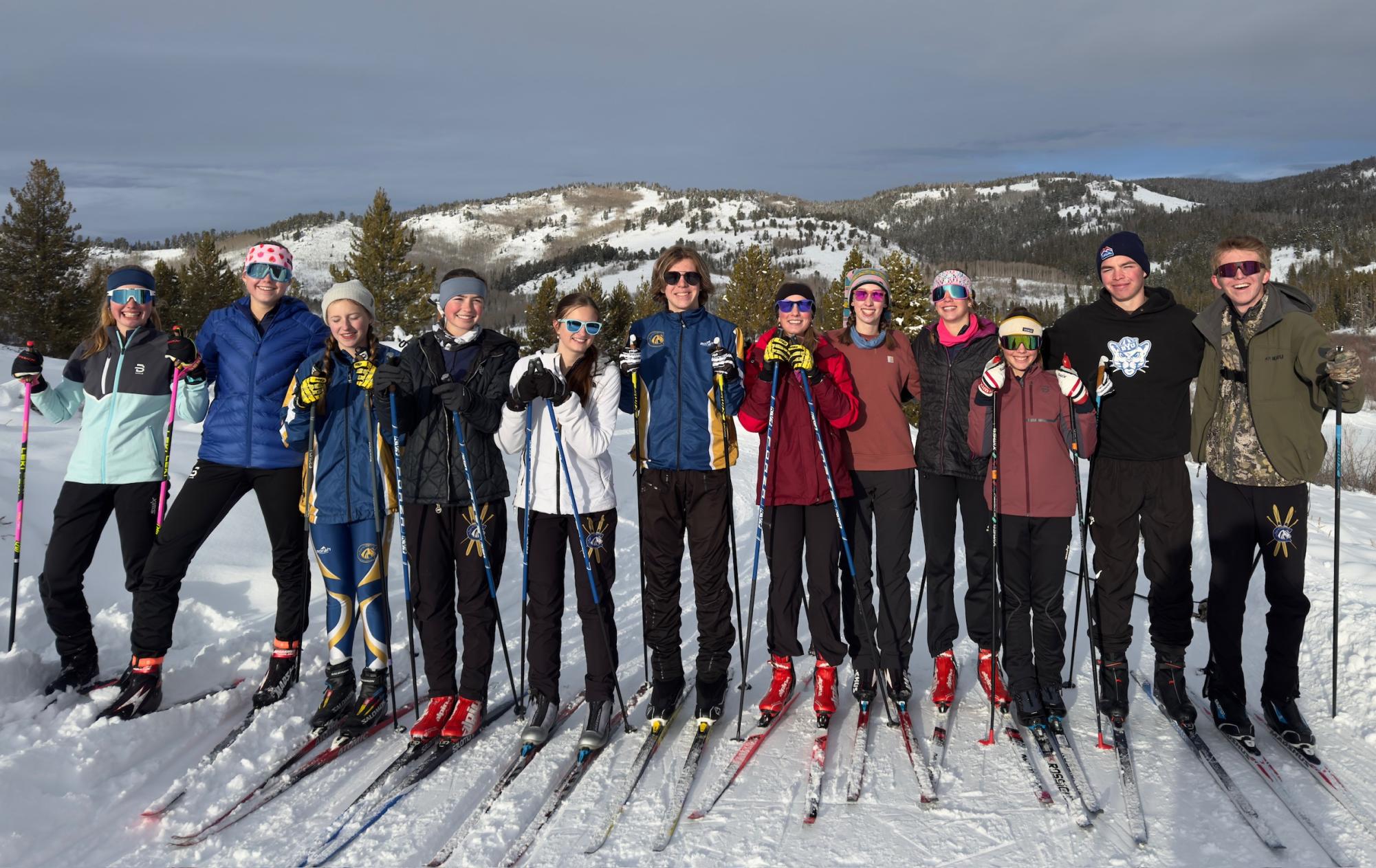 The CHS Nordic ski team smiles for a picture after a race.