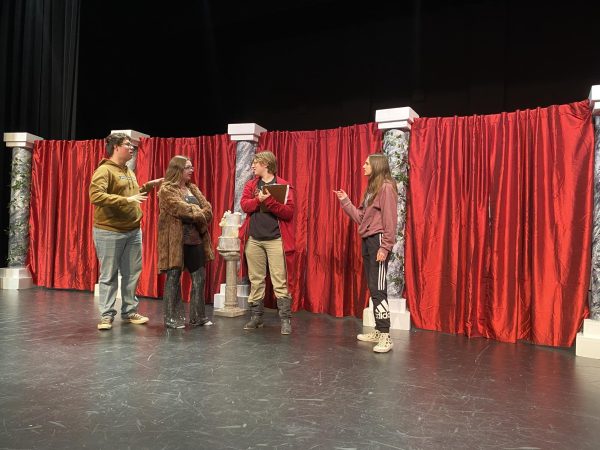 Actors rehearse on stage for “The Wedding Intern’s Farce” production.