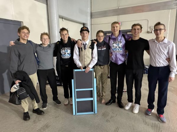 The boys' swim team takes a photo together after the state swim meet.