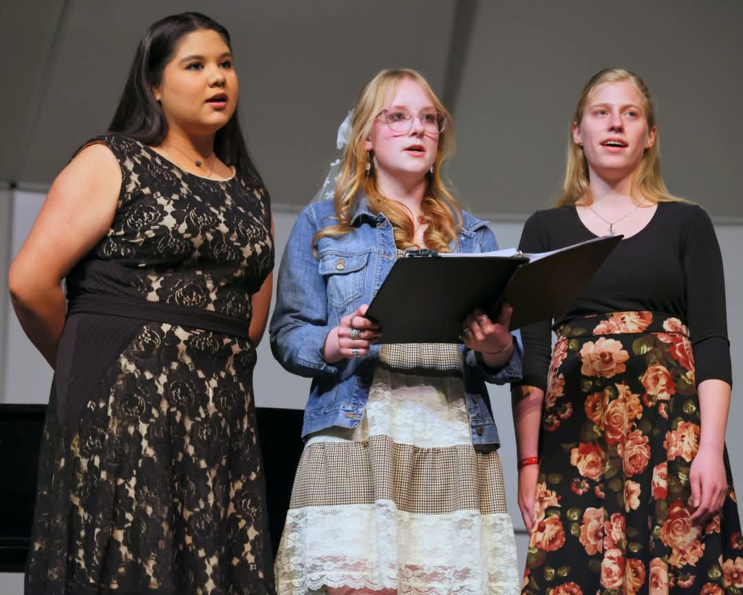 PHS seniors Nayeli Esparza, Brenna Henderson, and Jordan Black sing "Riversong" in their senior ensemble.