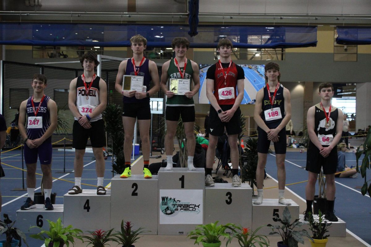 Sophomore Lincoln Crawford stands on the podium after placing 4th in 55-meter hurdles.