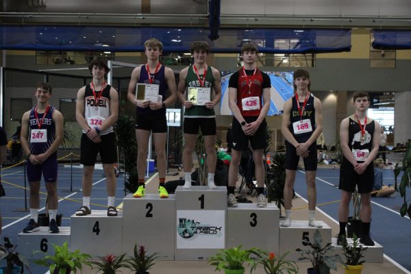 Sophomore Lincoln Crawford stands on the podium after placing 4th in 55-meter hurdles.