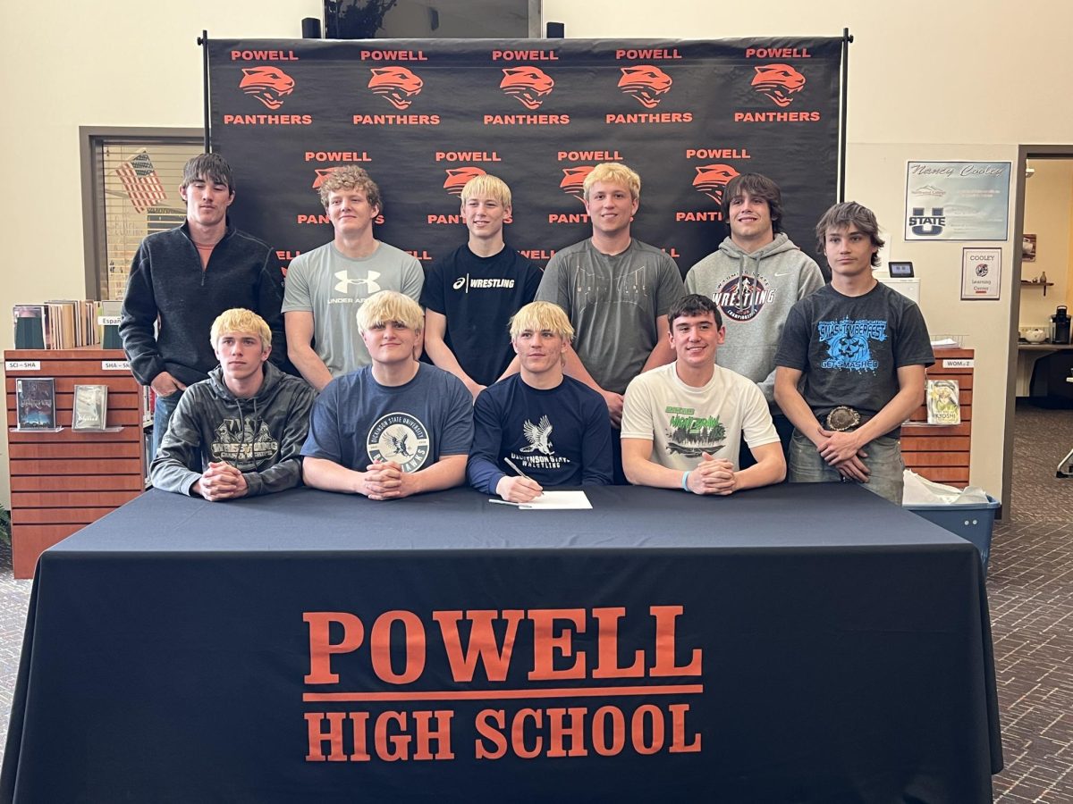 Wainscott and his team pose for a photo after he signed with the Blue Hawks.