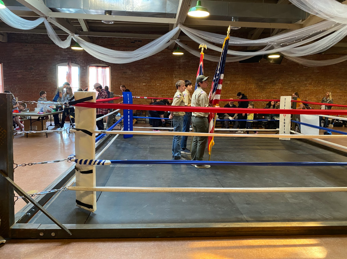 Powell’s Boy Scouts holds flags during the National Anthem in the boxing ring.