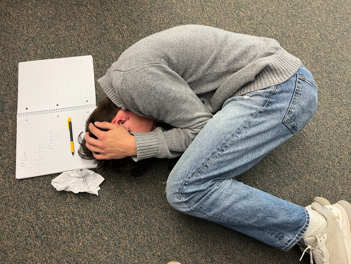 Isaac Dunsey lies on the ground, crumpled in a ball, crying in response to the AP exams.