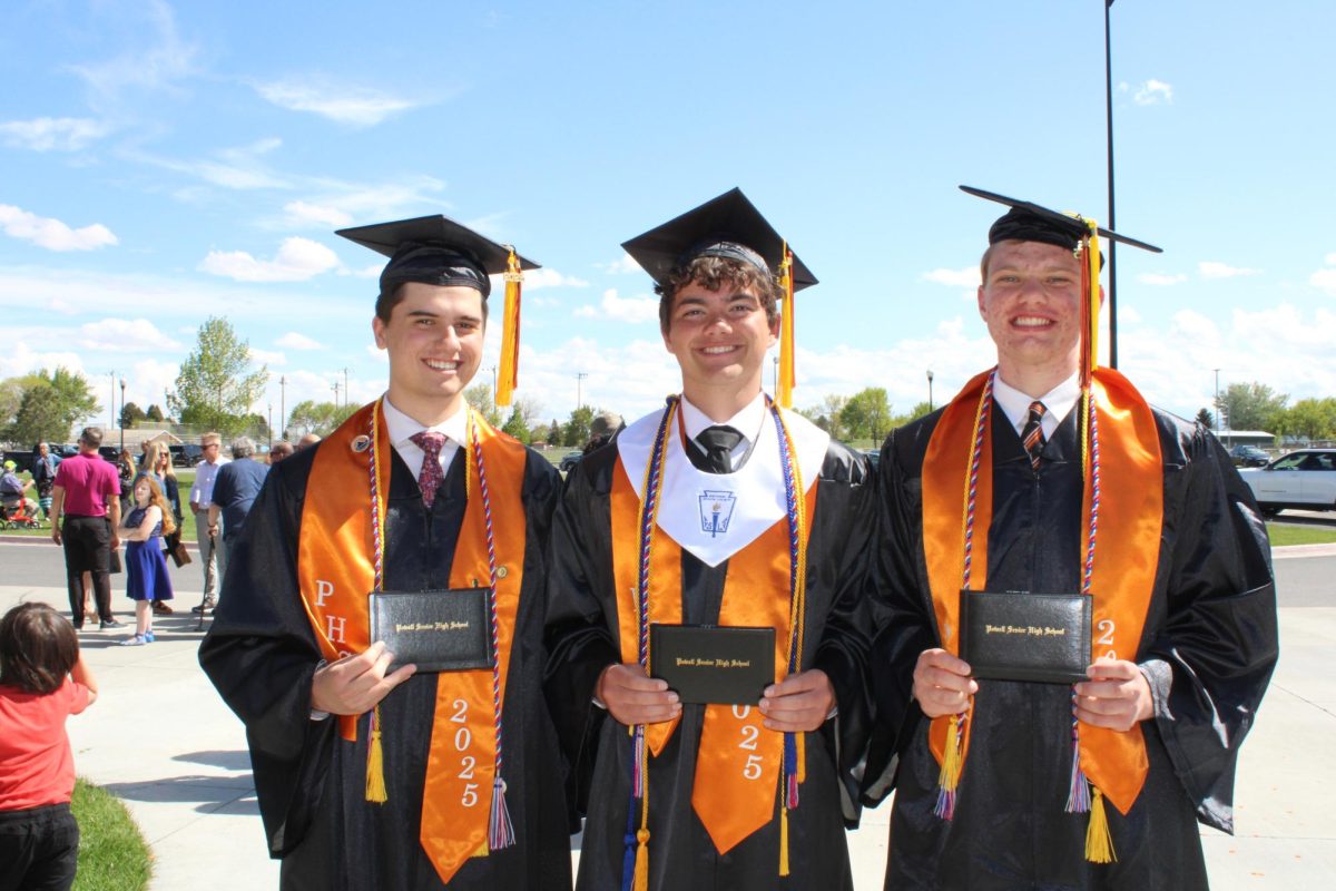 Alan Crawford, Dexter Opps, and Dallin Waite pose with their diplomas after graduation. 