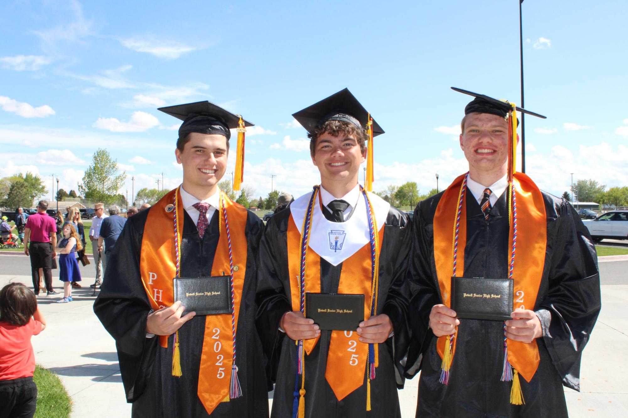 Alan Crawford, Dexter Opps, and Dallin Waite pose with their diplomas after graduation. 