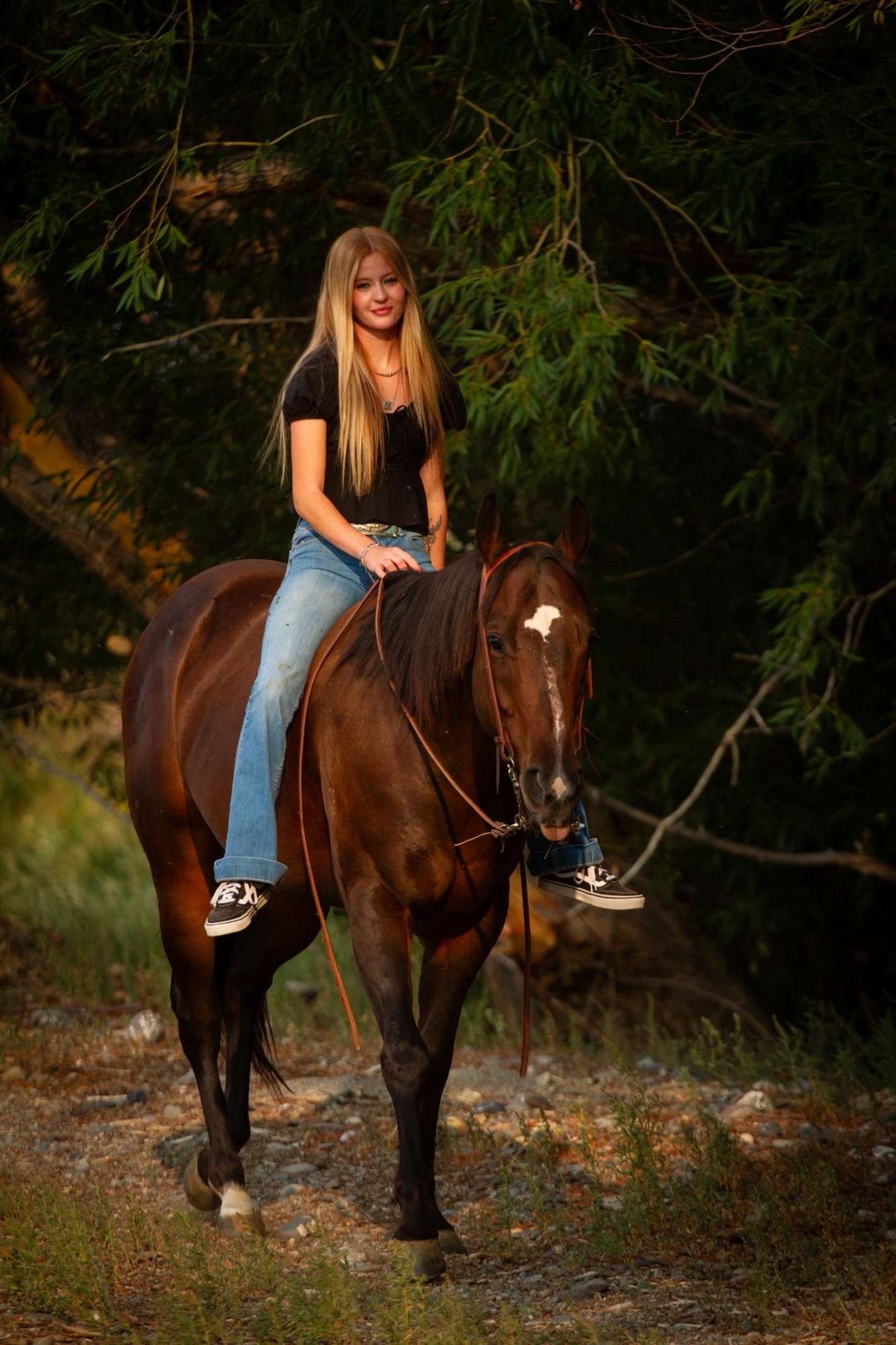 Chapter Sweetheart, Josie Werner, rides her horse during senior pictures.