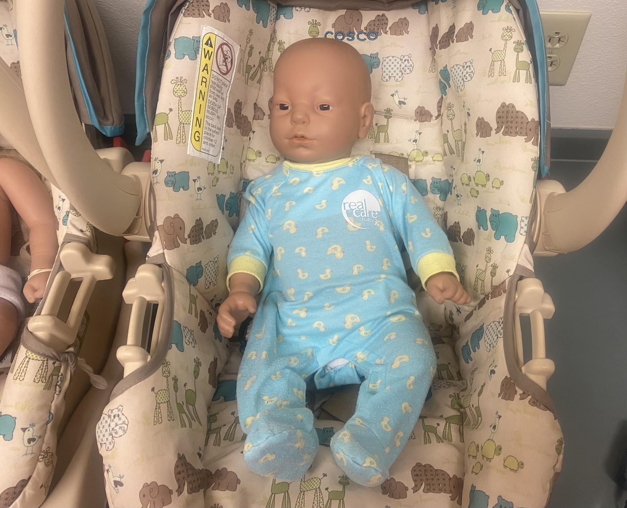 This robot baby, one of the many robots taken home by Human Growth and Development students, waits to meet its parents.