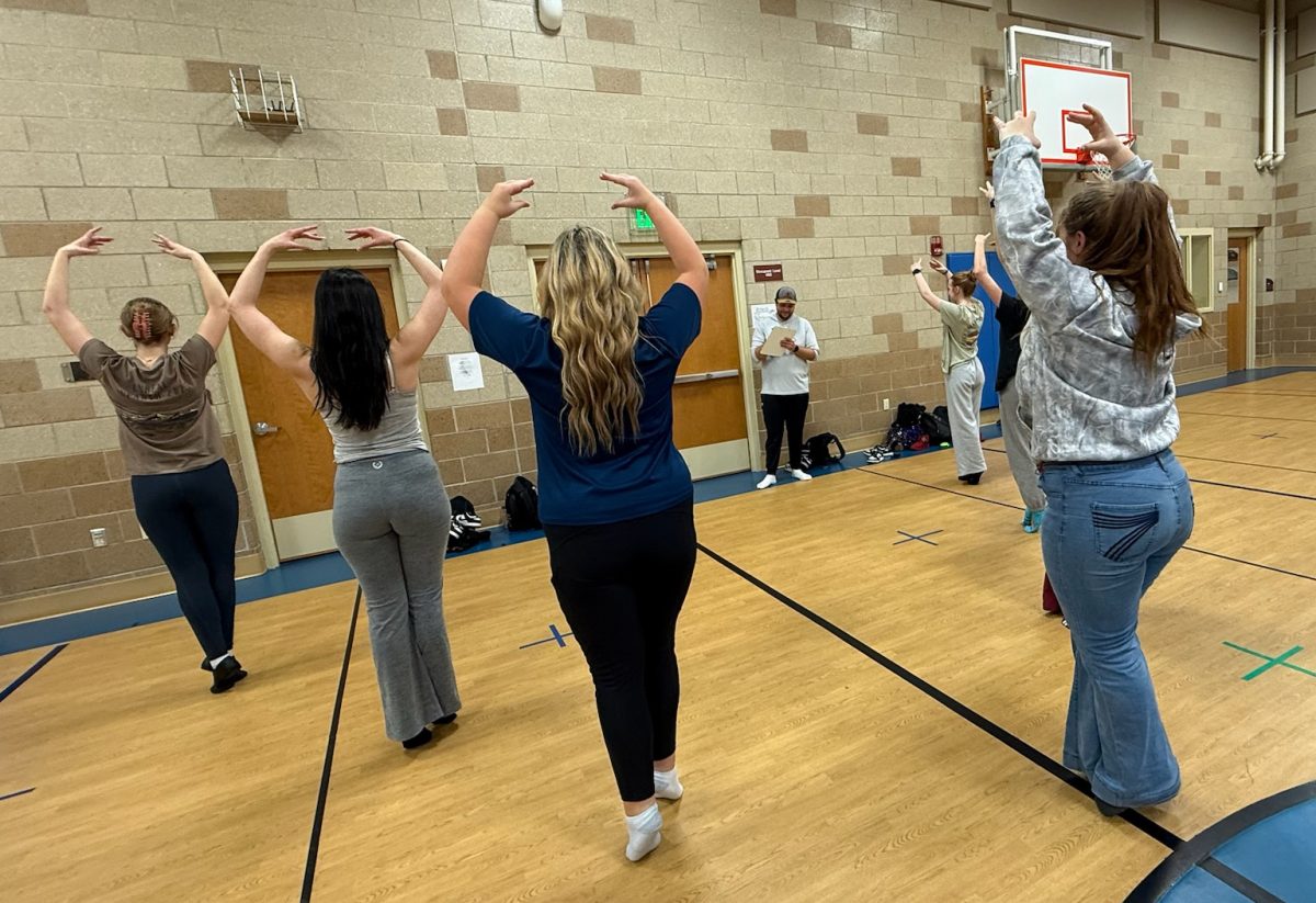 Choreographer Jaxton Braten aids the dance team with their routines in preparation for state.