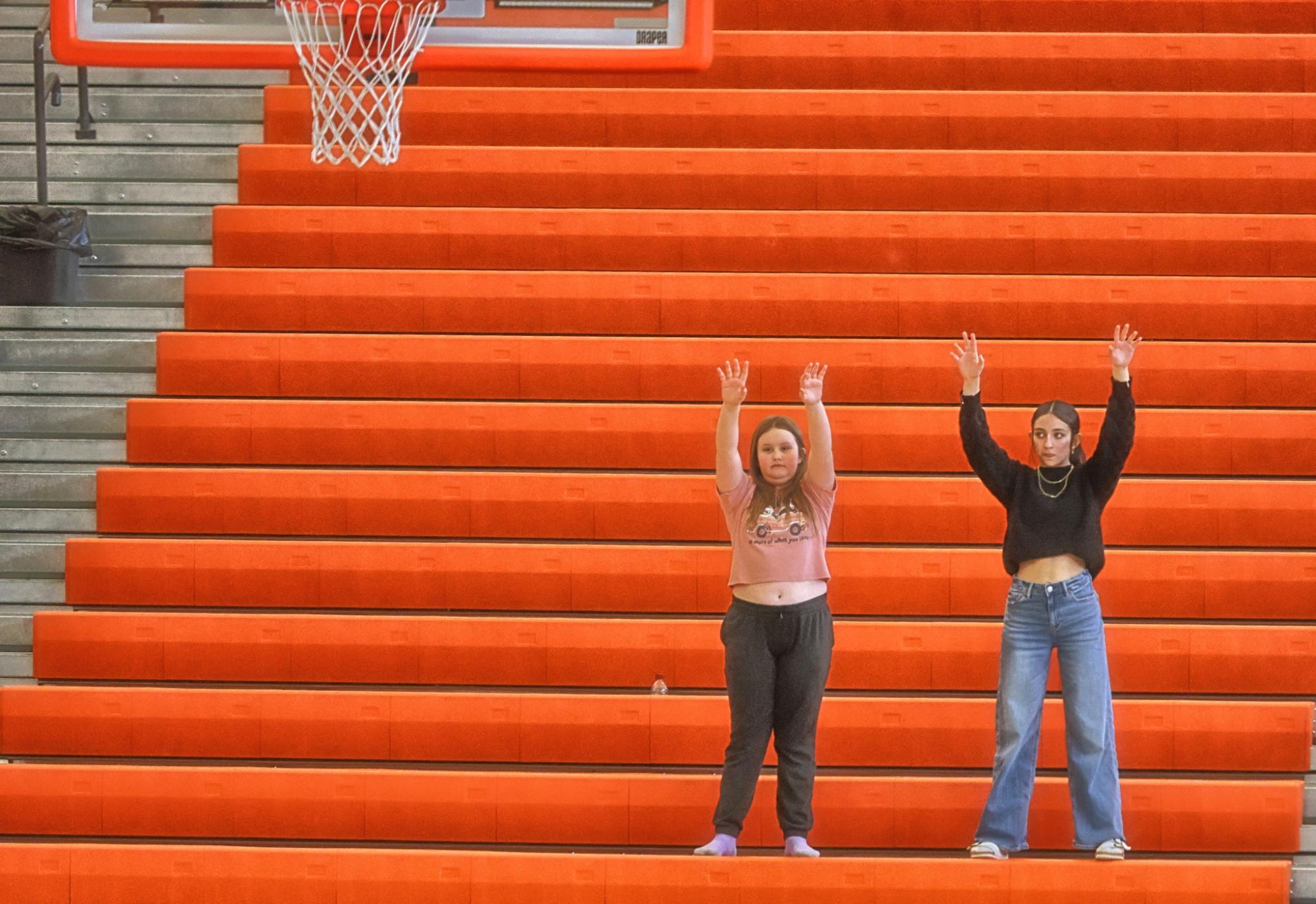 Two students occupy a normally-packed student section at the home basketball game on February 7.