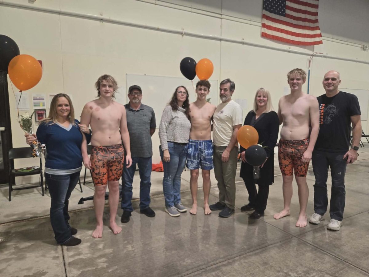 Seniors, Trystan Preator, Will Fuller, Hugh Carpenter, and their parents celebrate senior night.