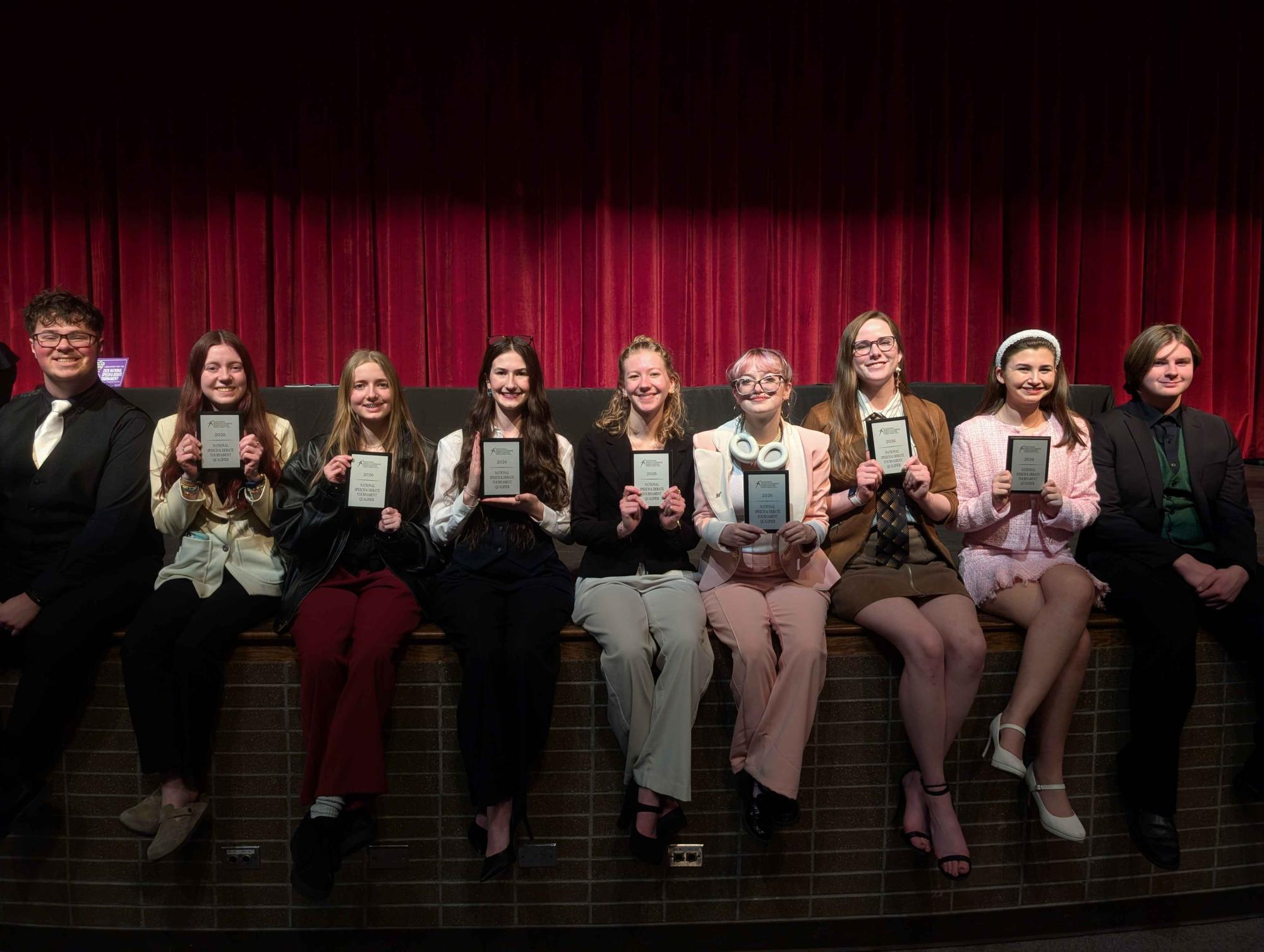 The speech and debate team smiles with their awards after the tournament (L to R: Curtis Muckee, Natalie Black, Chloe Camp, Taylor Peters, Kyra Morrow, Paige McConnell, Katerina Retiz, LeeAnne Phillips, Justin Dusenberry)