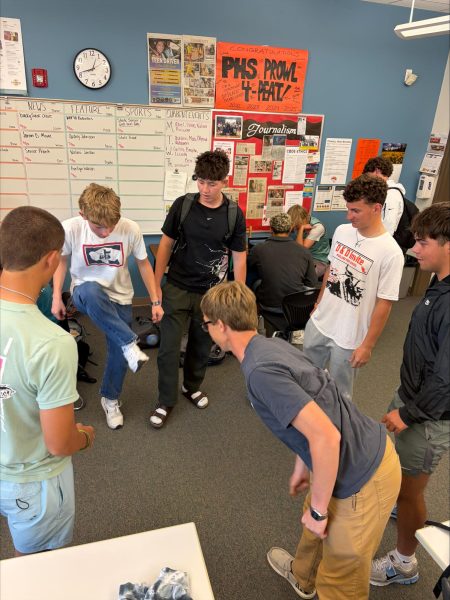 Junior and senior boys cautiously circle the once-again-popular hacky sack. In circle L-R: Tanner Siefert, Tucker Phillips, Ostin Kolb, Breckyn Kobbe, Cody Fisher, and Korbyn Warren.